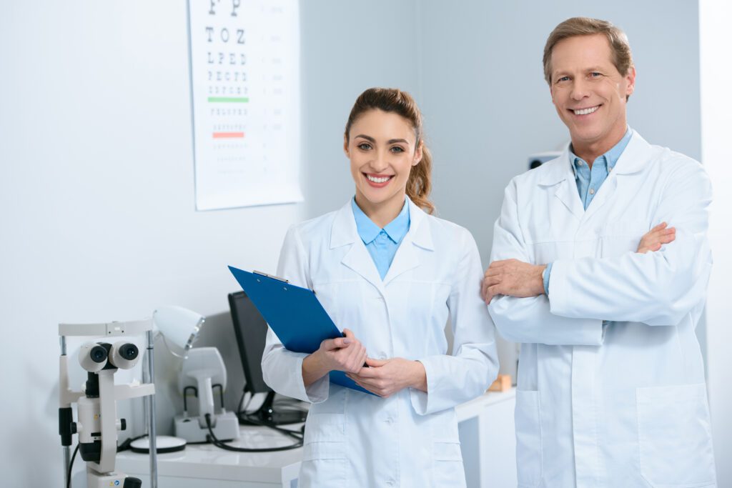 Optometrists, male and female optometrist, optometrist in an optical clinc, male and female optometrist in an optical clinic, optometrists smiling in an optical clinic