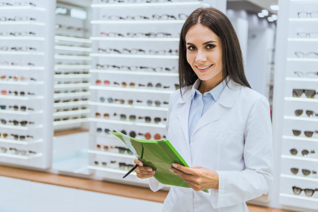 optician, optician in the eyeglass store, female optician, female optician smiling in the eyeglass store