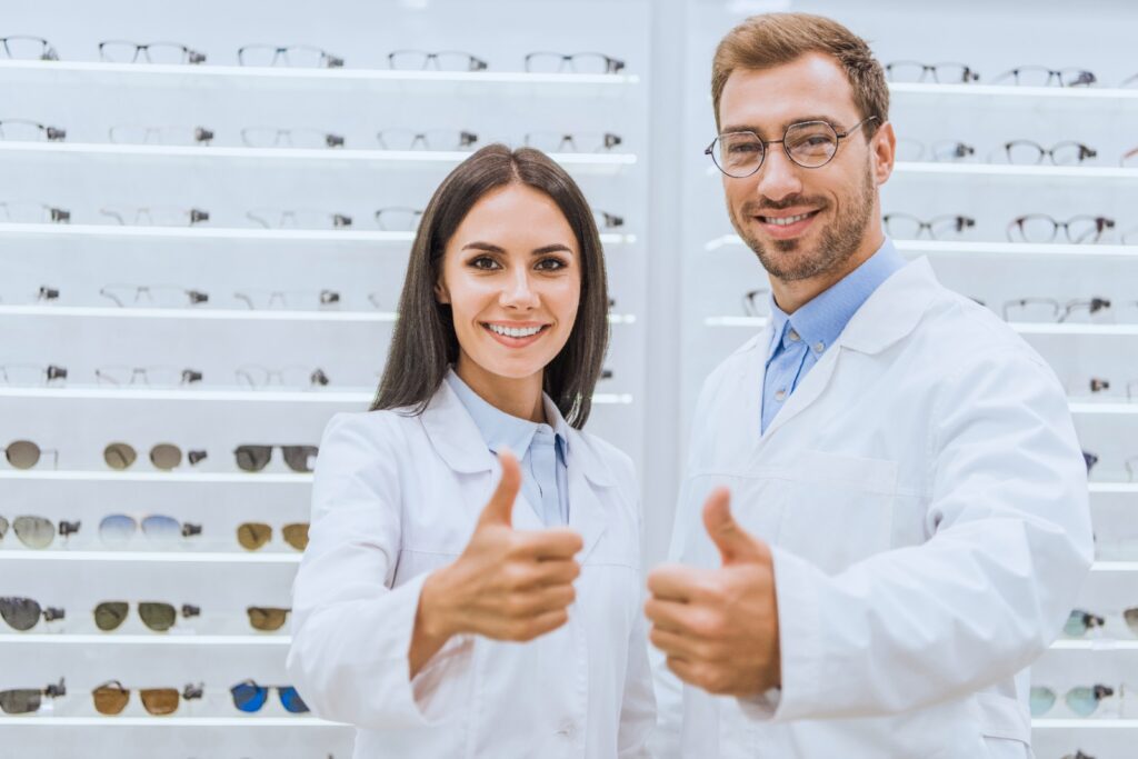 opticians, opticians in the eyeglass store, male and female optician, male and female optician in the eyeglass store