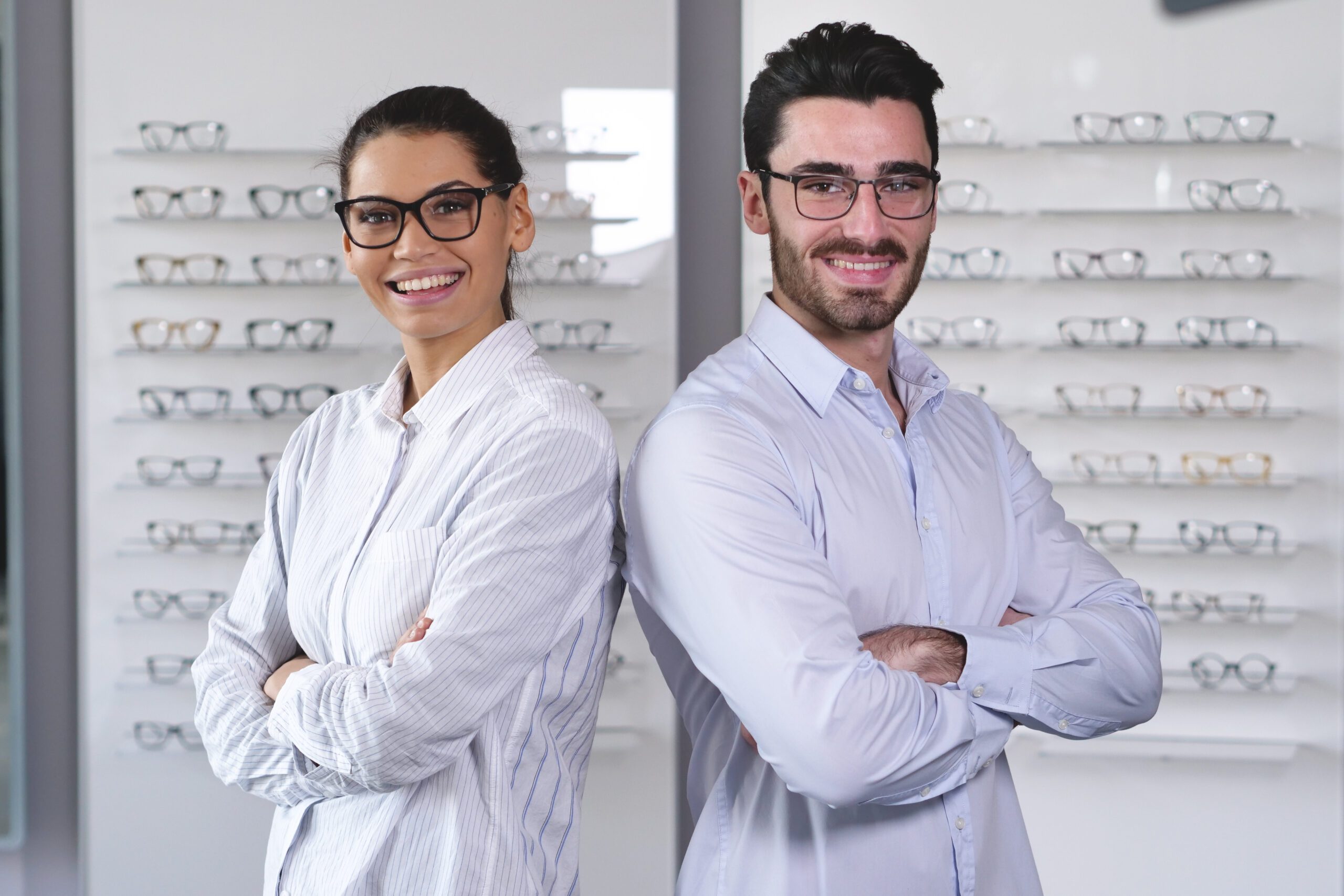 opticians, opticians in the eyeglass store, male and female optician, male and female optician in the eyeglass store