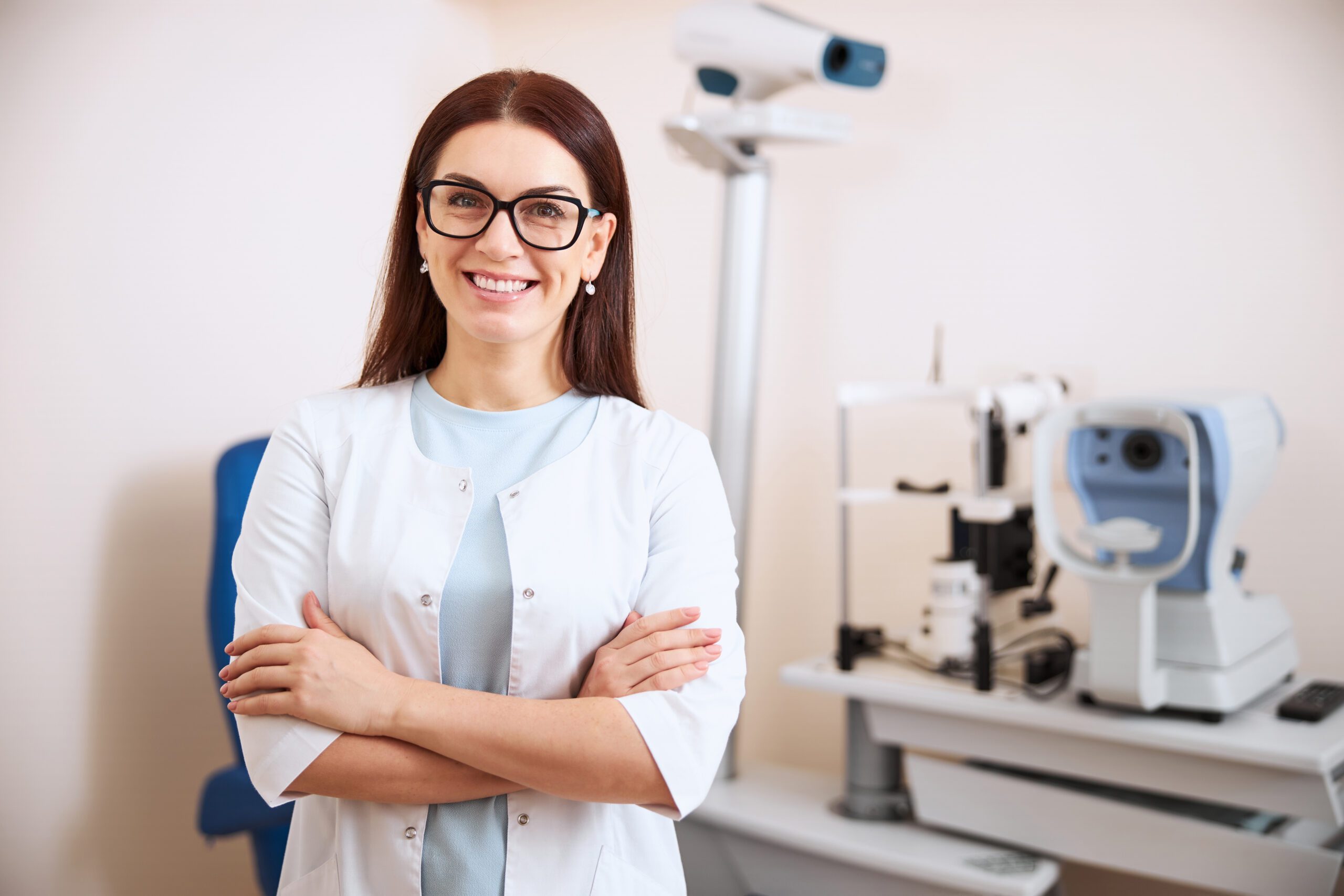 optometrist, female optometrist, female optometrist holding opthalmoscope